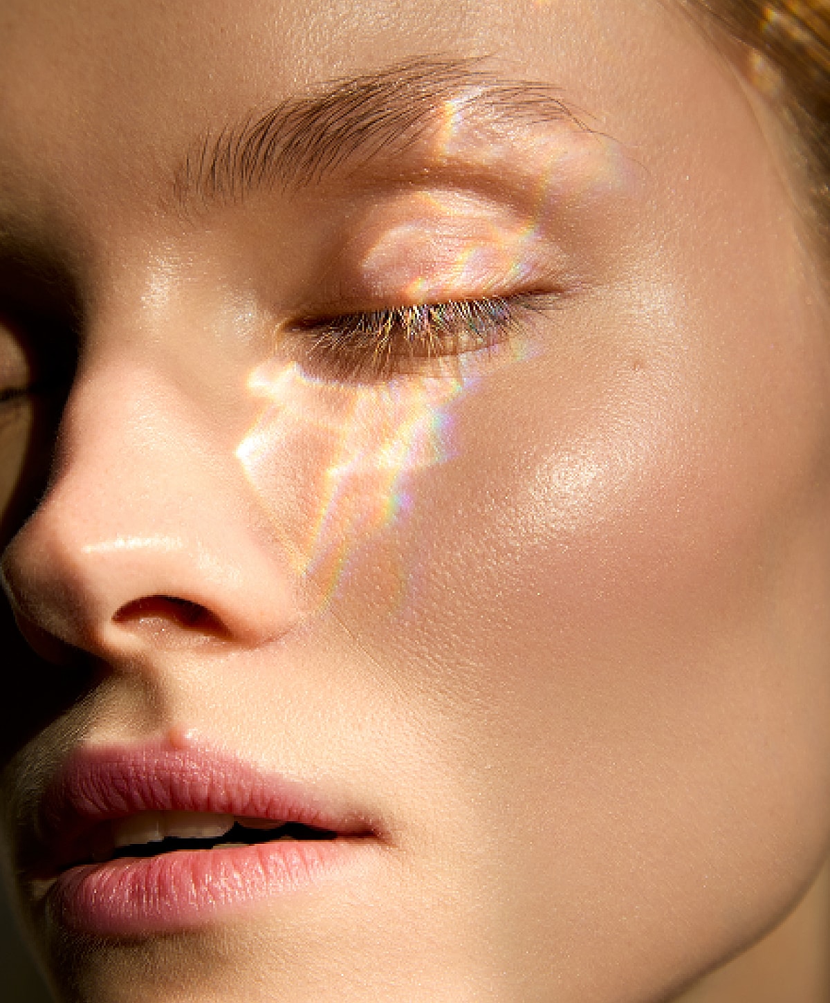 Close-up of a woman's face with light reflections.