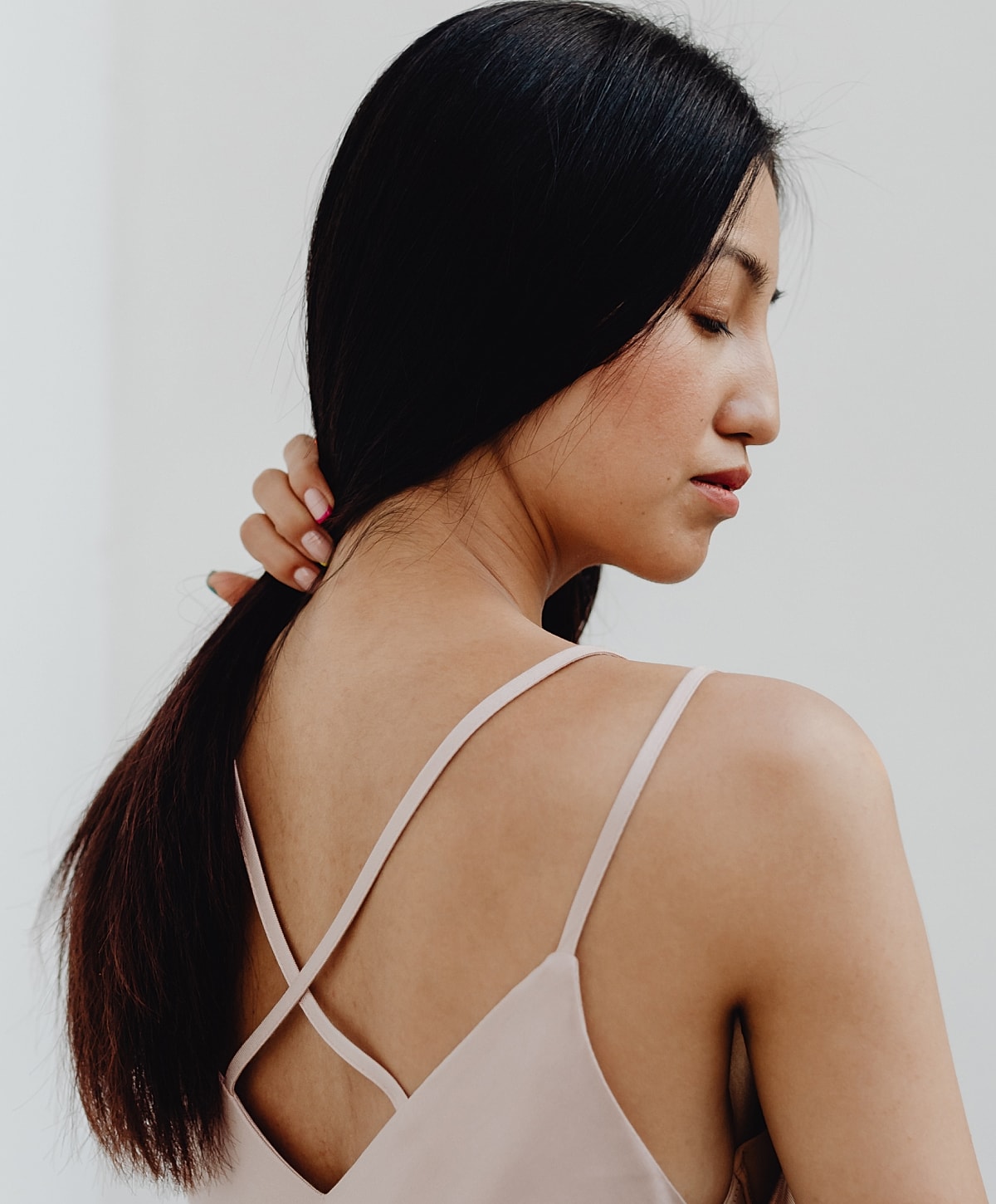 Woman looking over her shoulder with long hair.