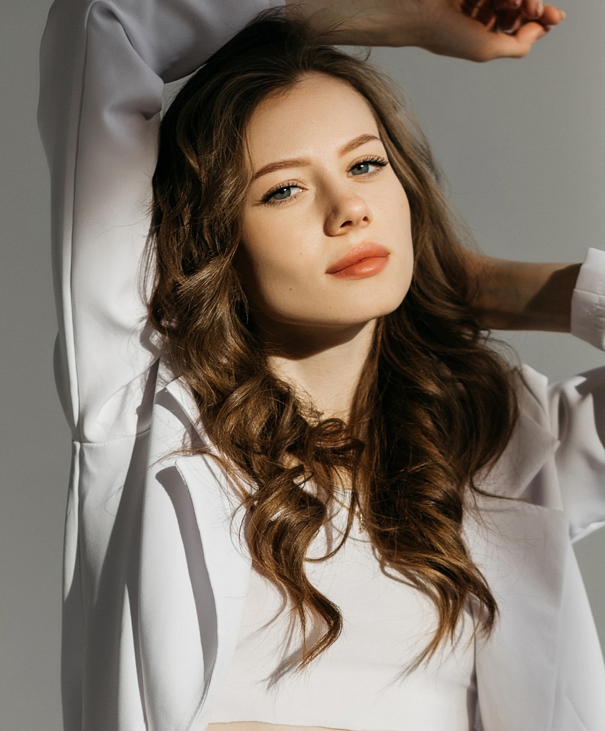 A woman posing with long, wavy hair.