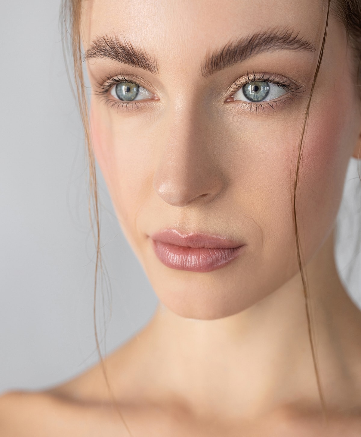 Close-up of a woman's face with natural makeup.