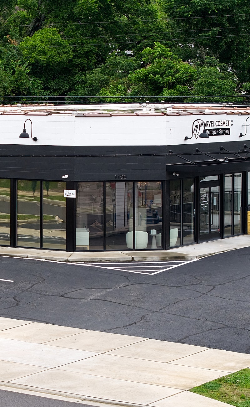 Historic white mansion with columns and pathway.