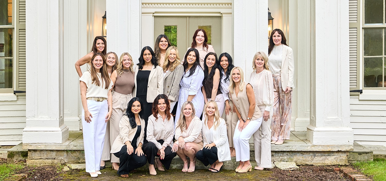 Group of women posing on a porch.