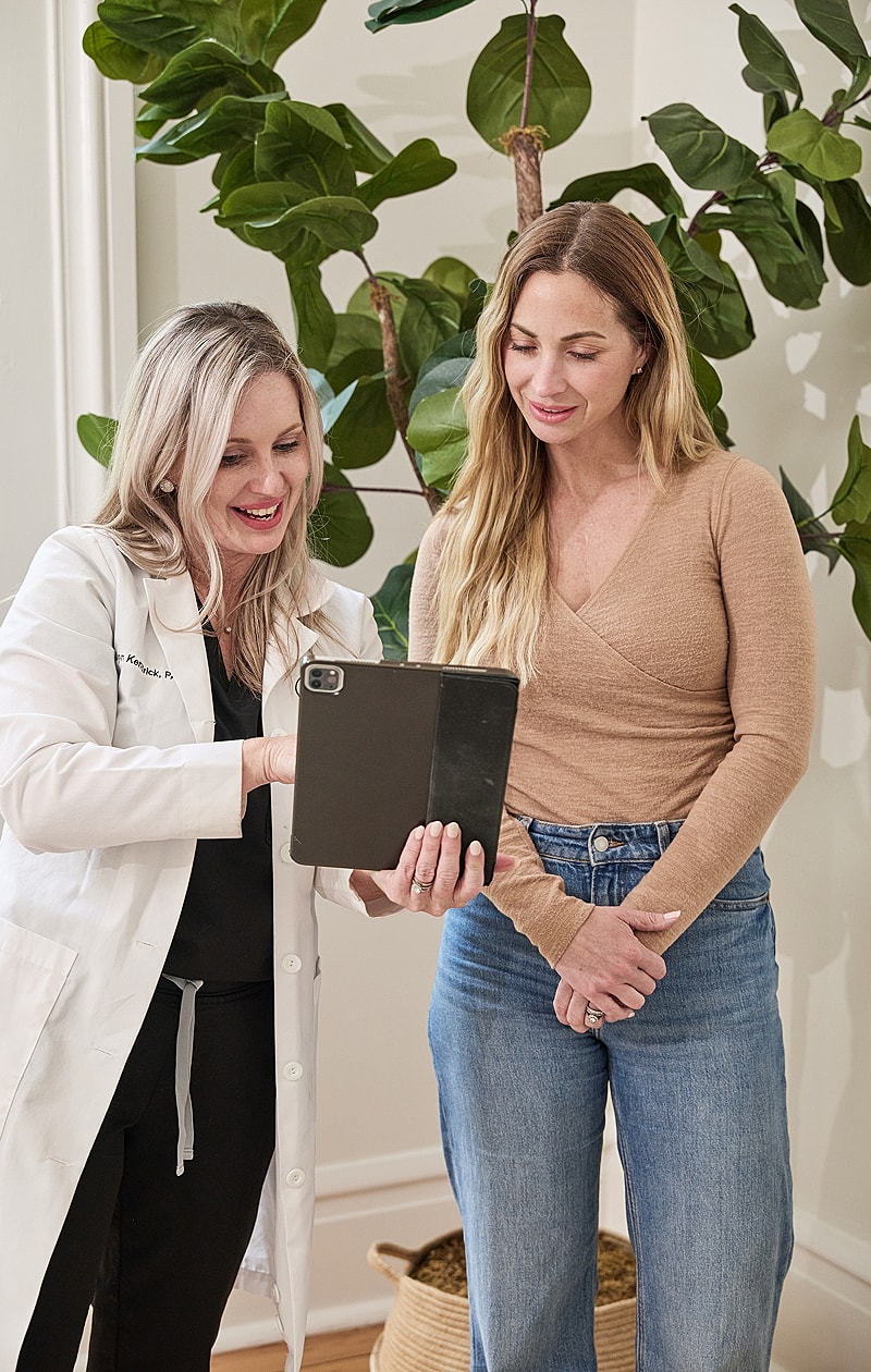 Consultation between doctor and patient with tablet.