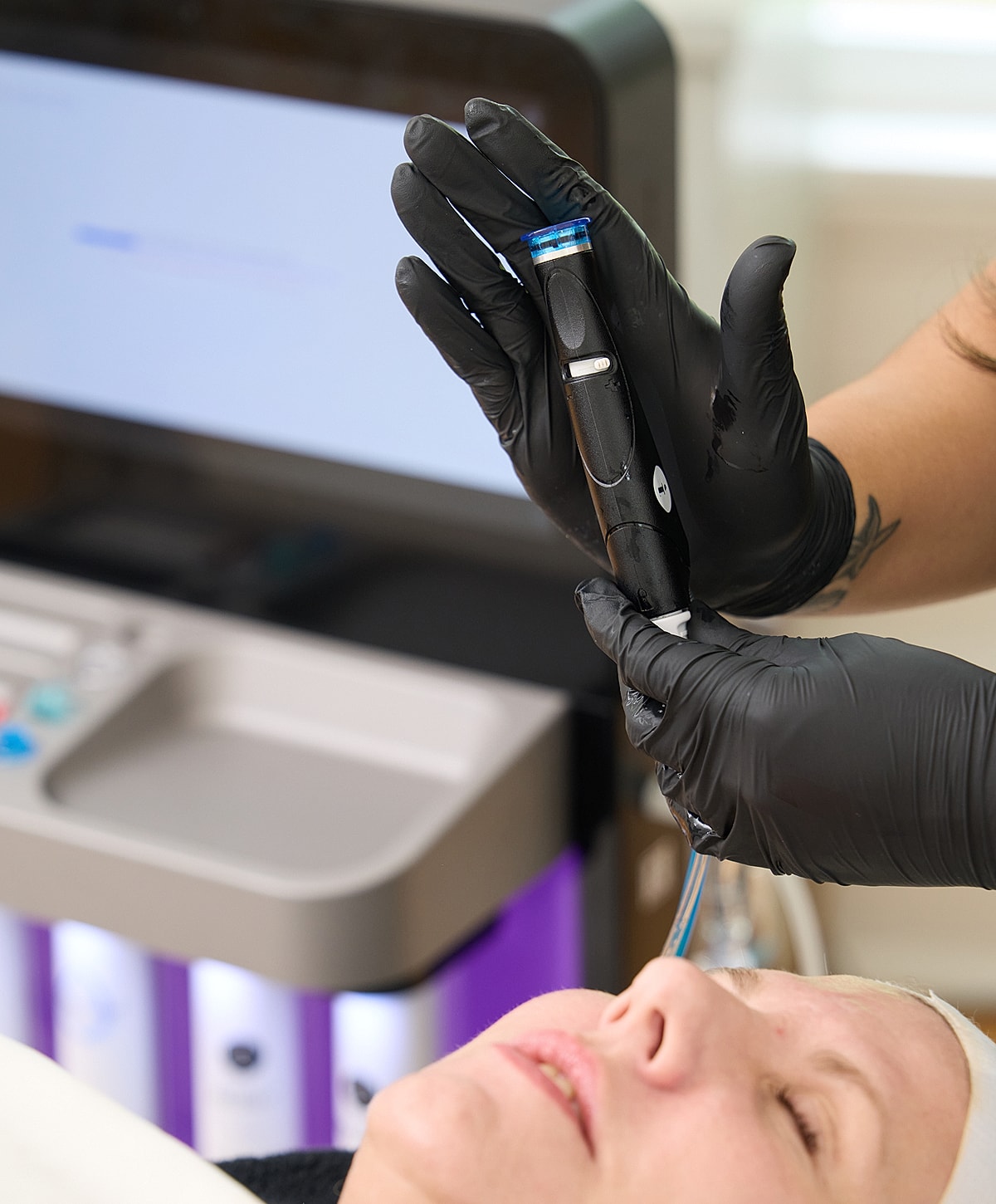 Client receiving facial treatment at beauty clinic.