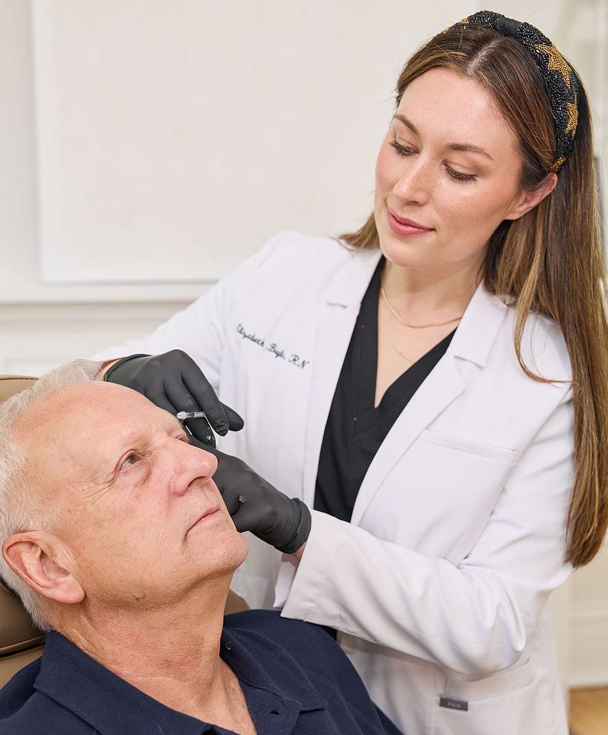 Medical professional administering treatment to patient.