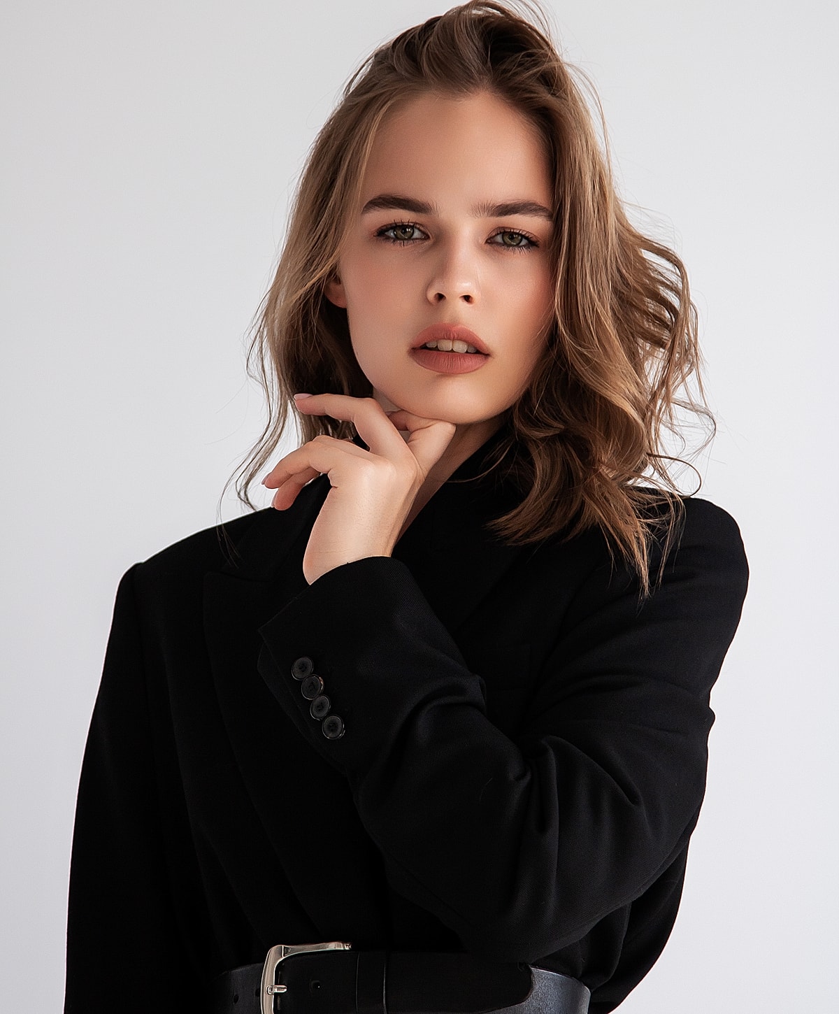 Model wearing gold teardrop earrings, stylish look.