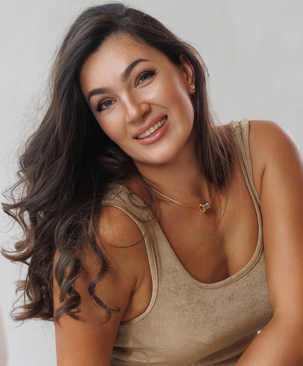 Smiling woman with long hair and casual attire.