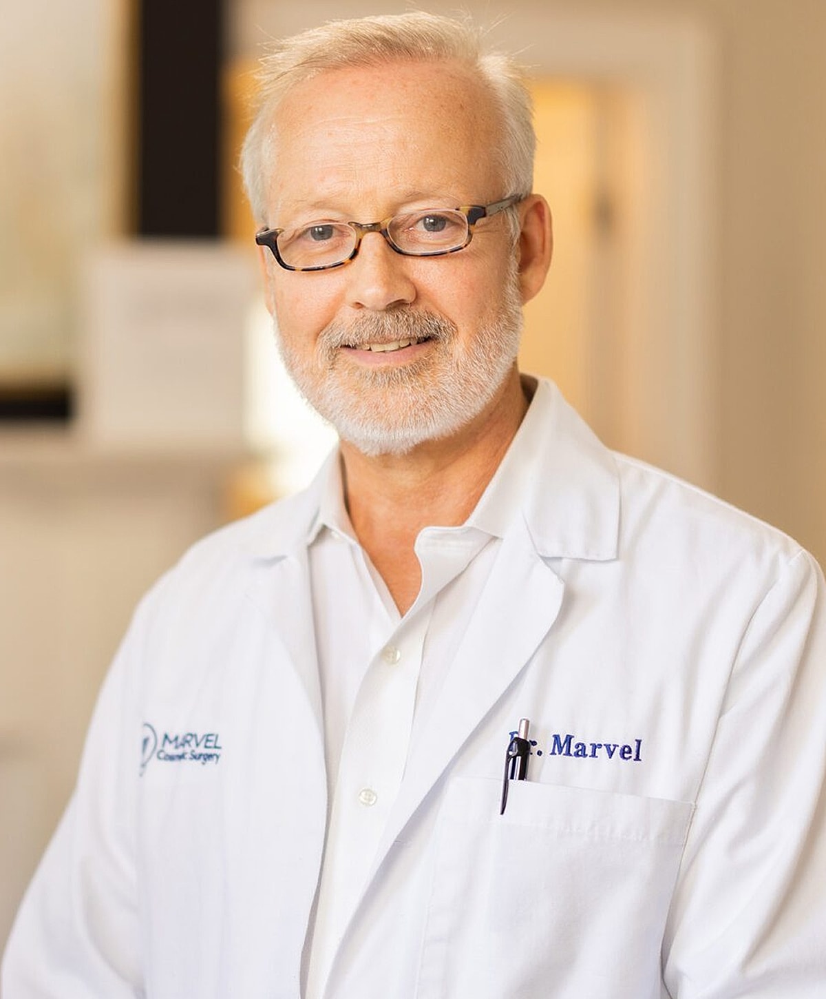 Doctor in medical coat smiling at camera.