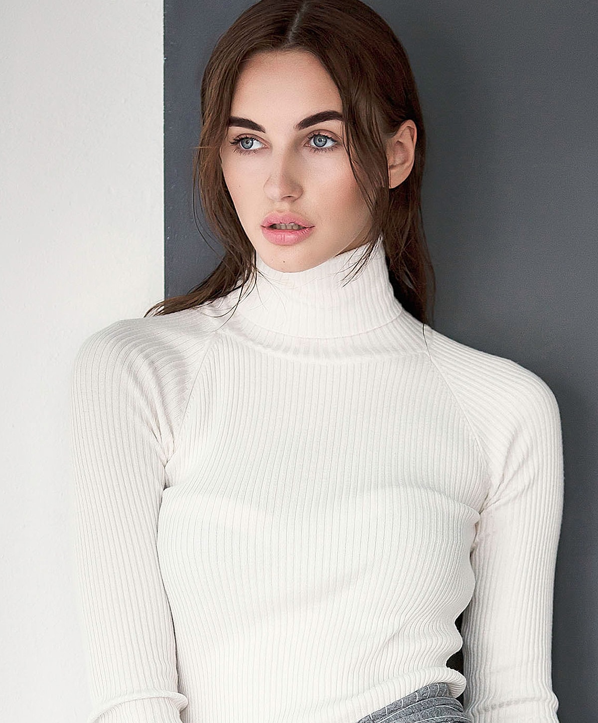 Model in a white turtleneck sweater portrait.