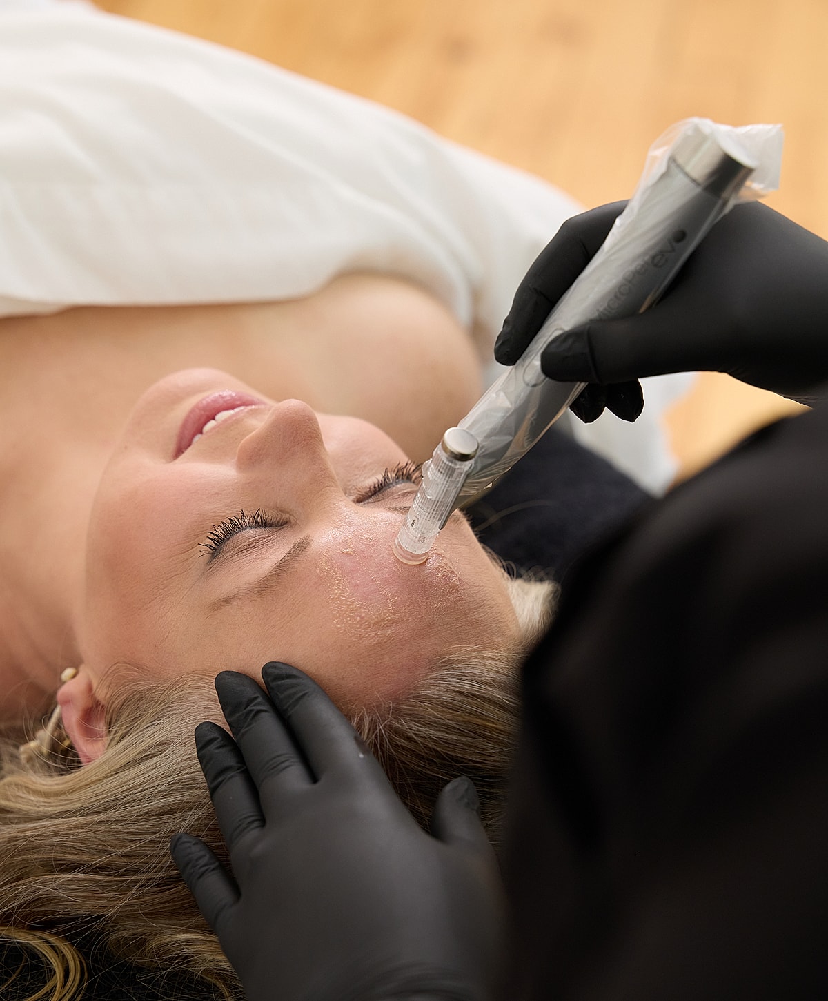 Client receiving facial treatment at beauty clinic.