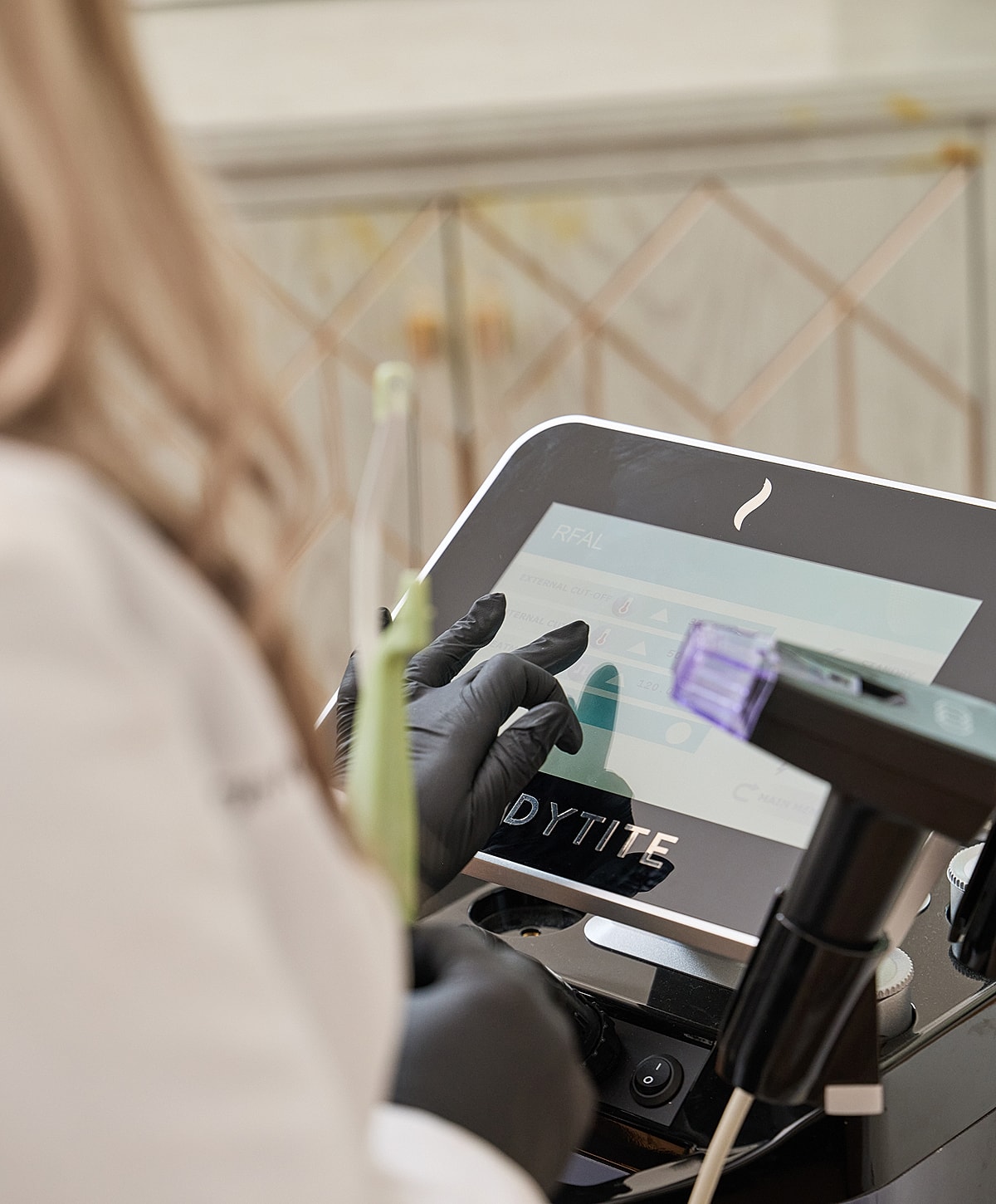 Technician operating advanced skincare treatment device.