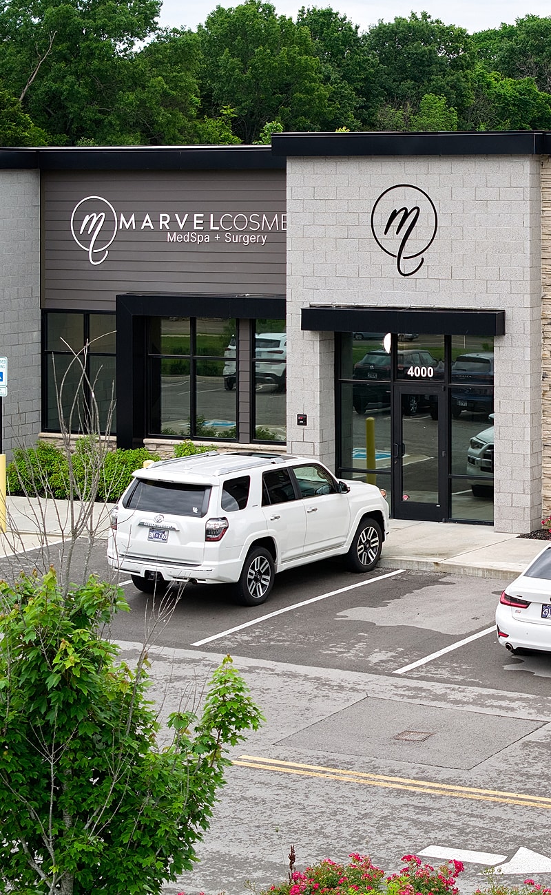 Historic white mansion with columns and pathway.