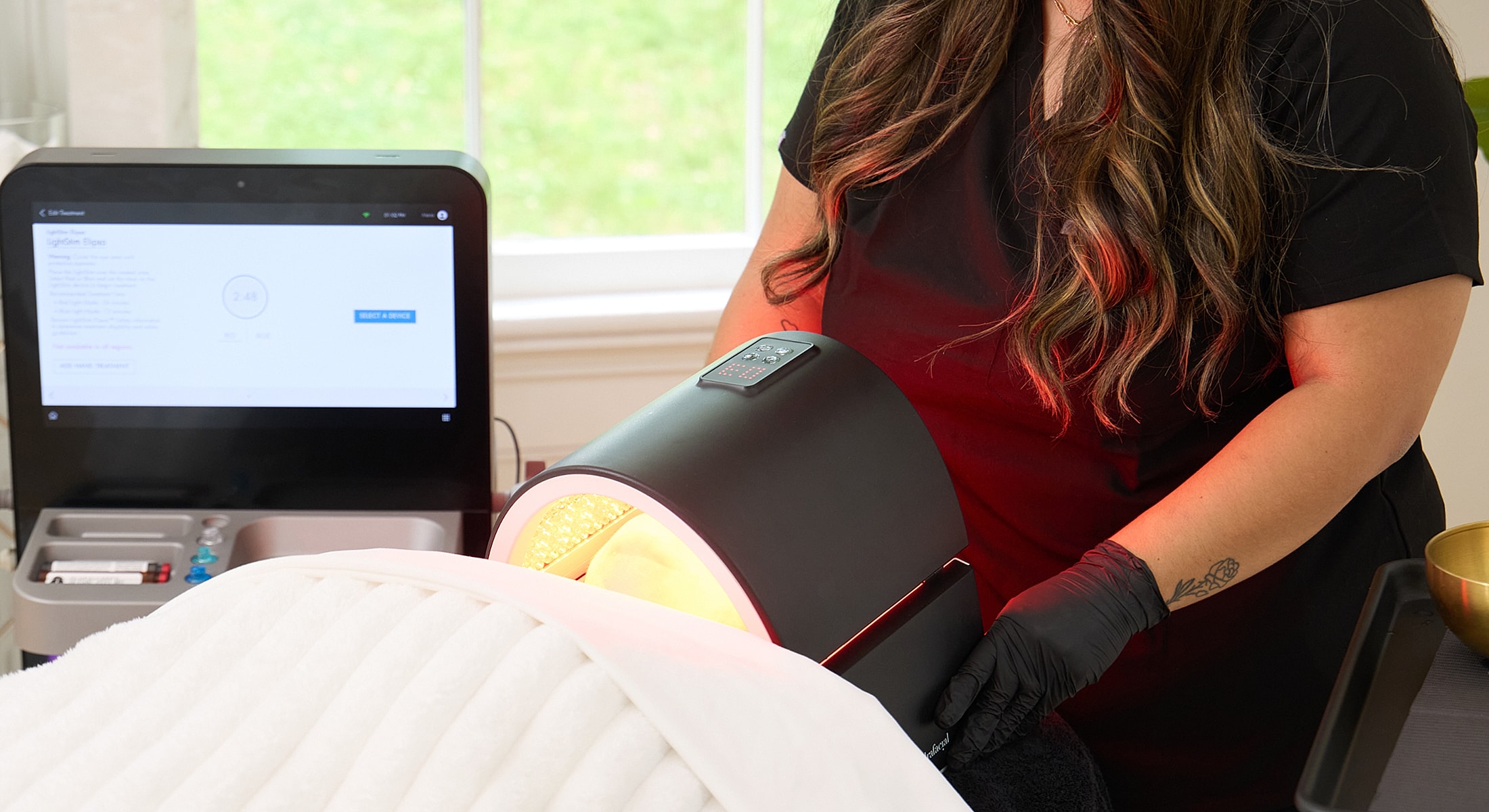 Nail treatment using LED light therapy device.