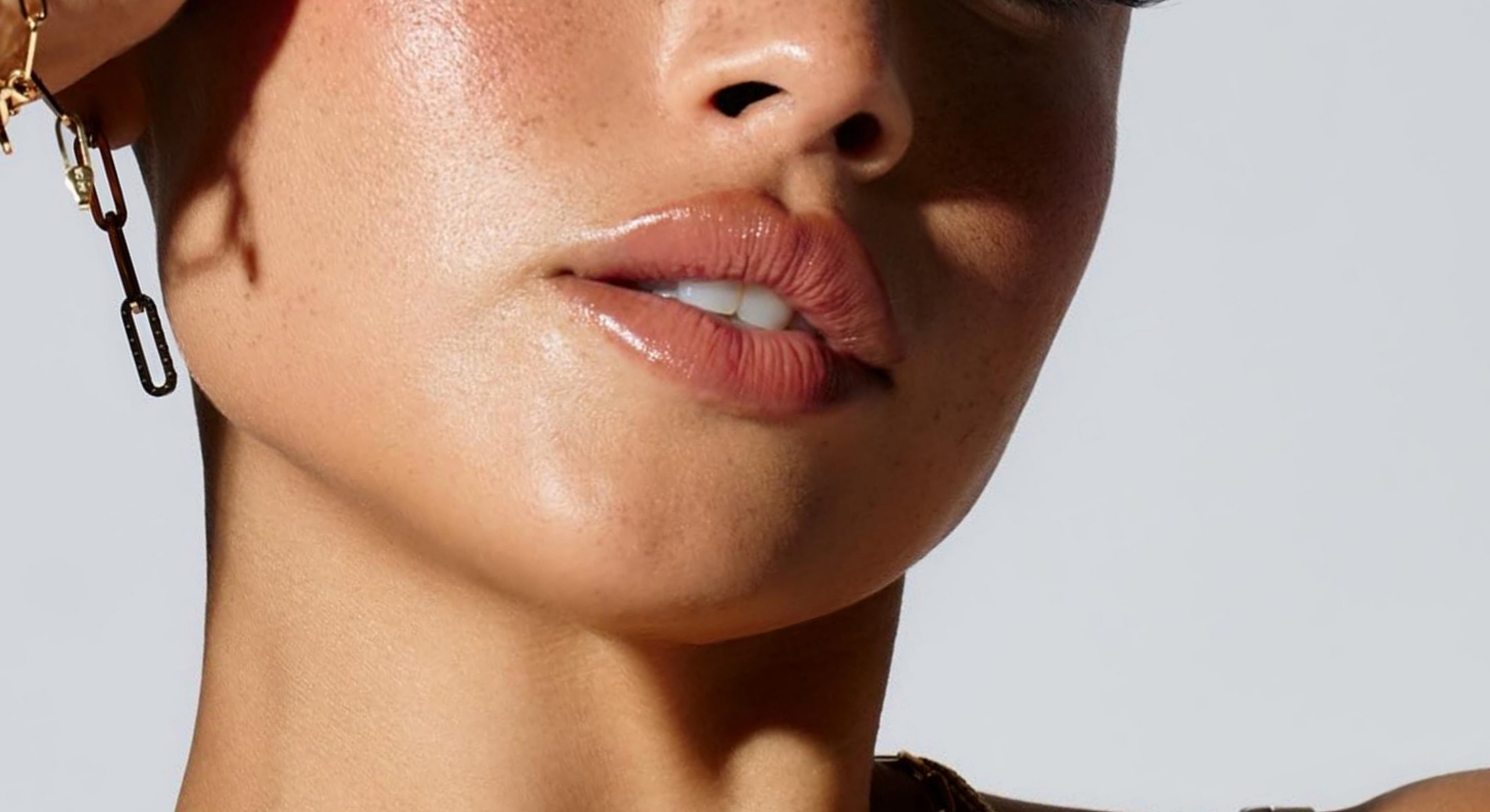 Close-up of a person's lips and jawline.