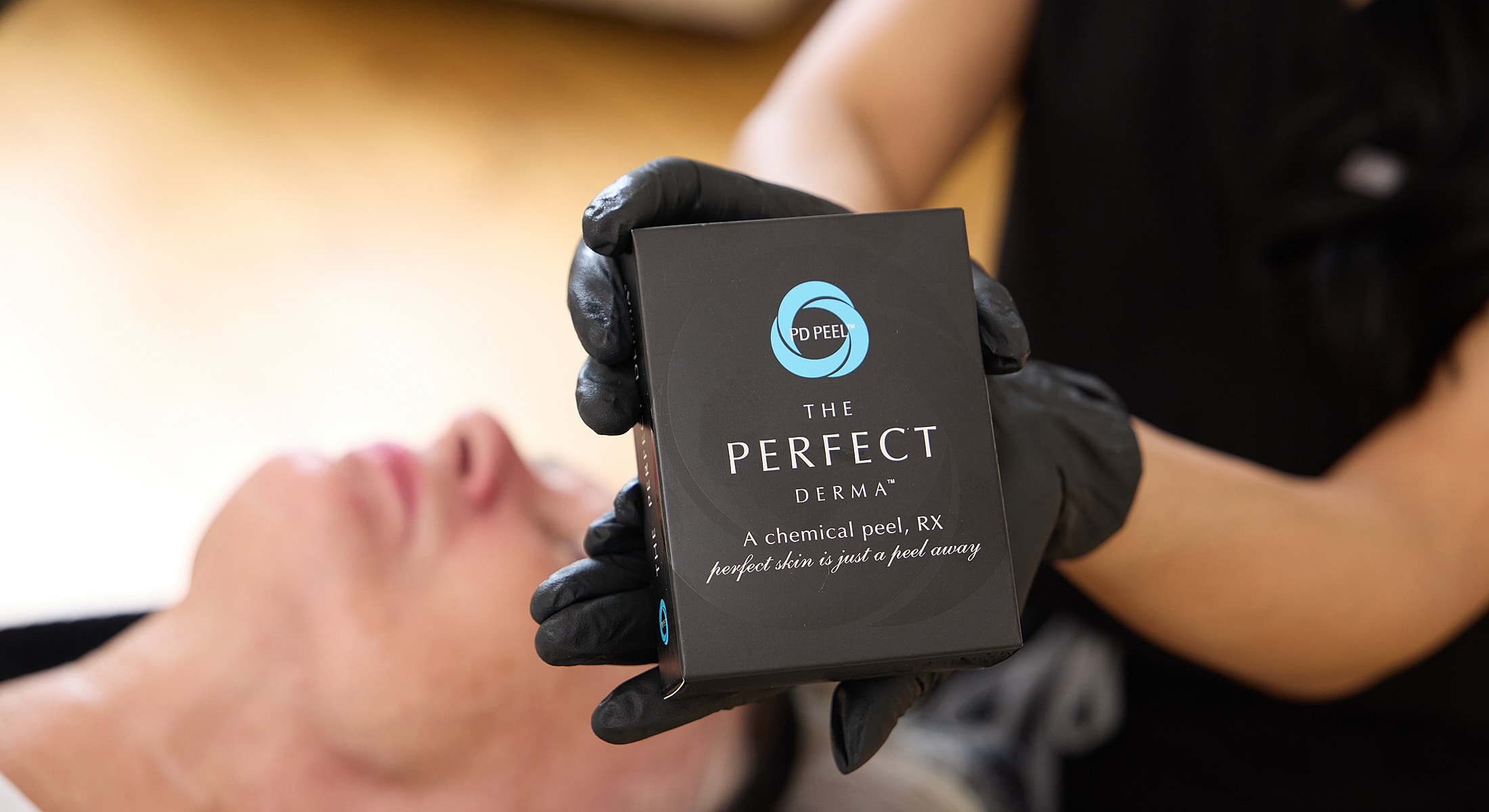 Chemical peel product being demonstrated on client.