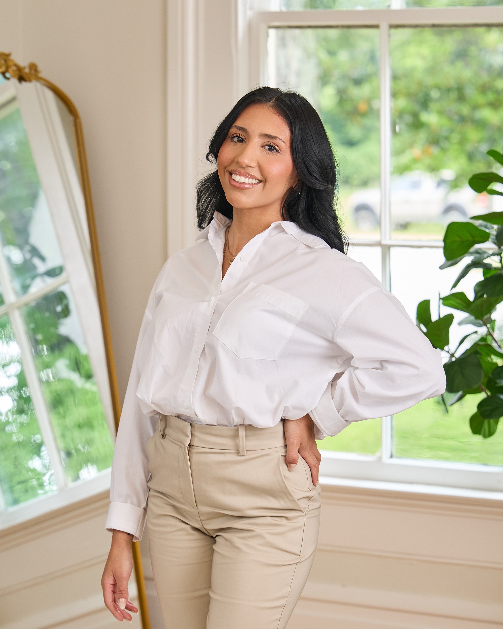 Smiling woman in casual attire indoors.