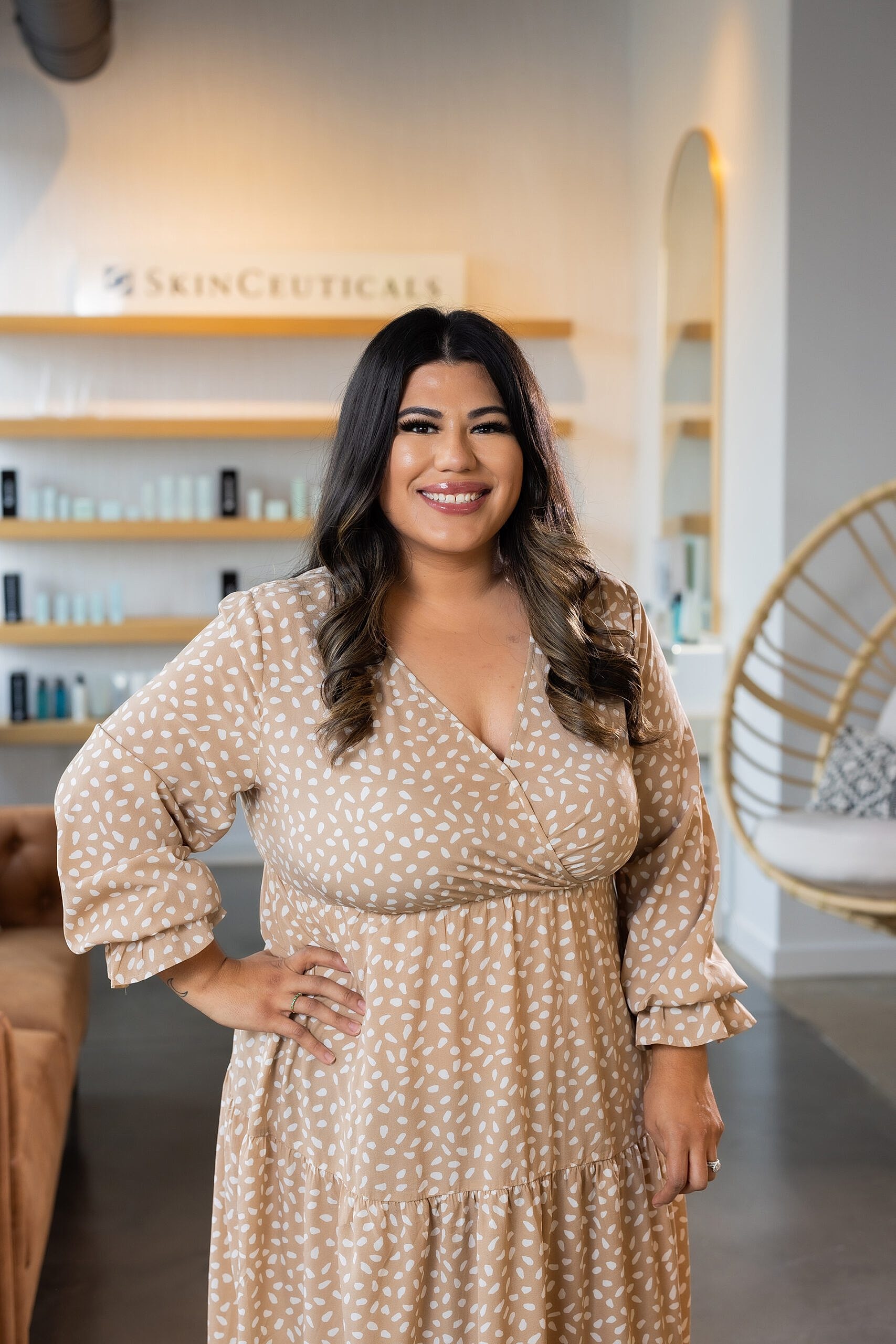 Smiling woman in a stylish dress indoors.