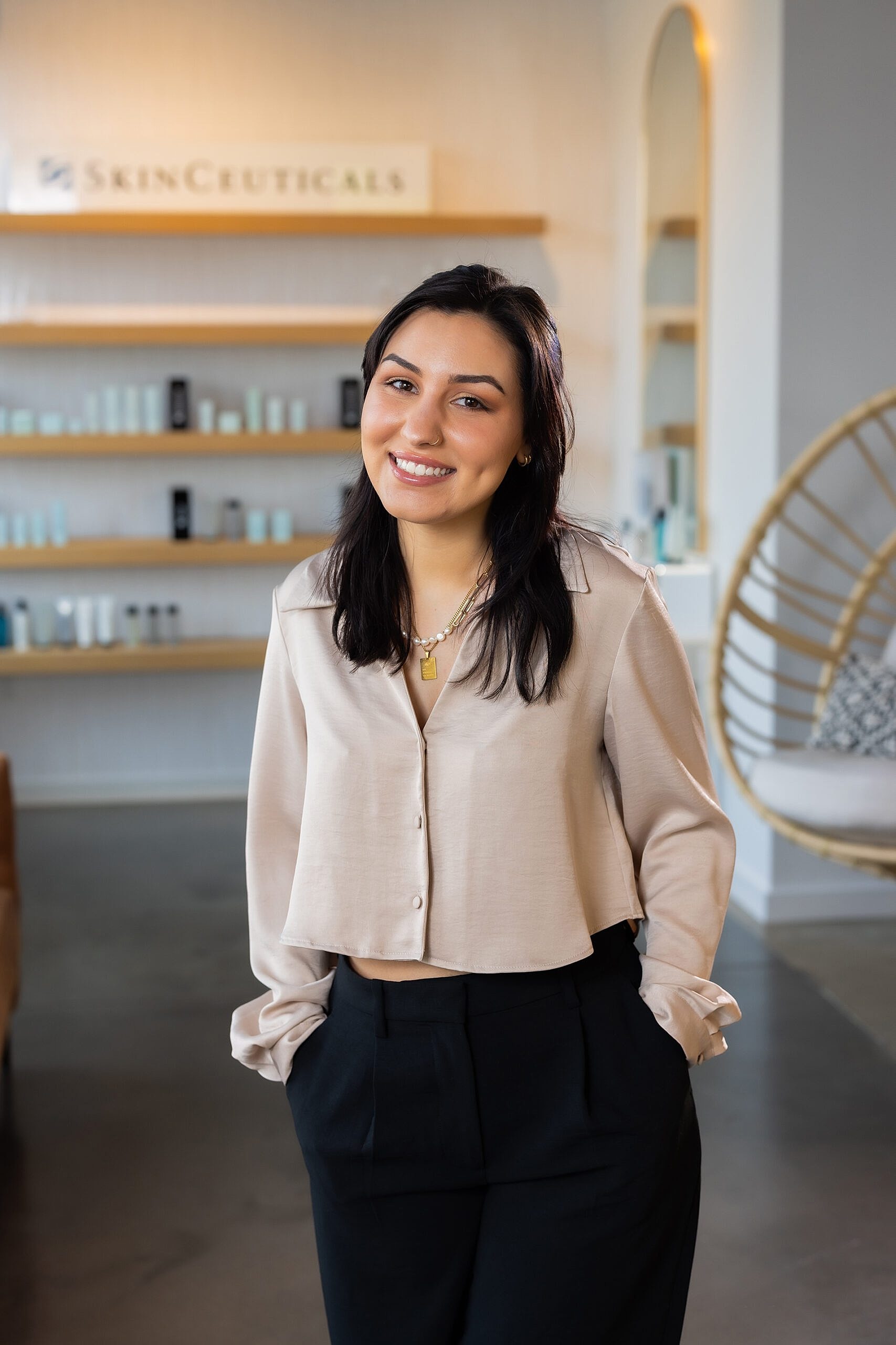 Smiling woman in a skincare studio setting.
