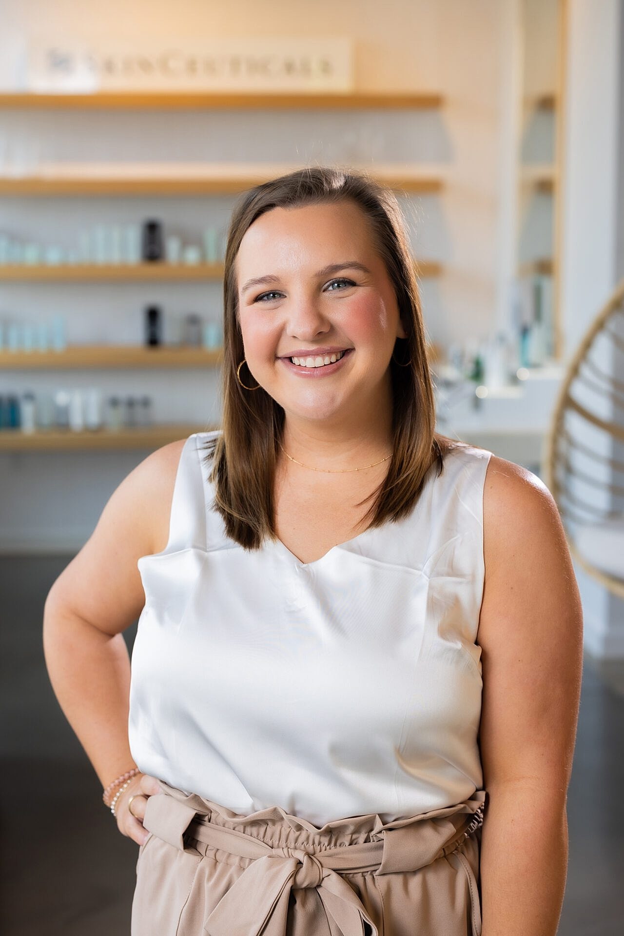 Smiling woman in professional skincare setting.