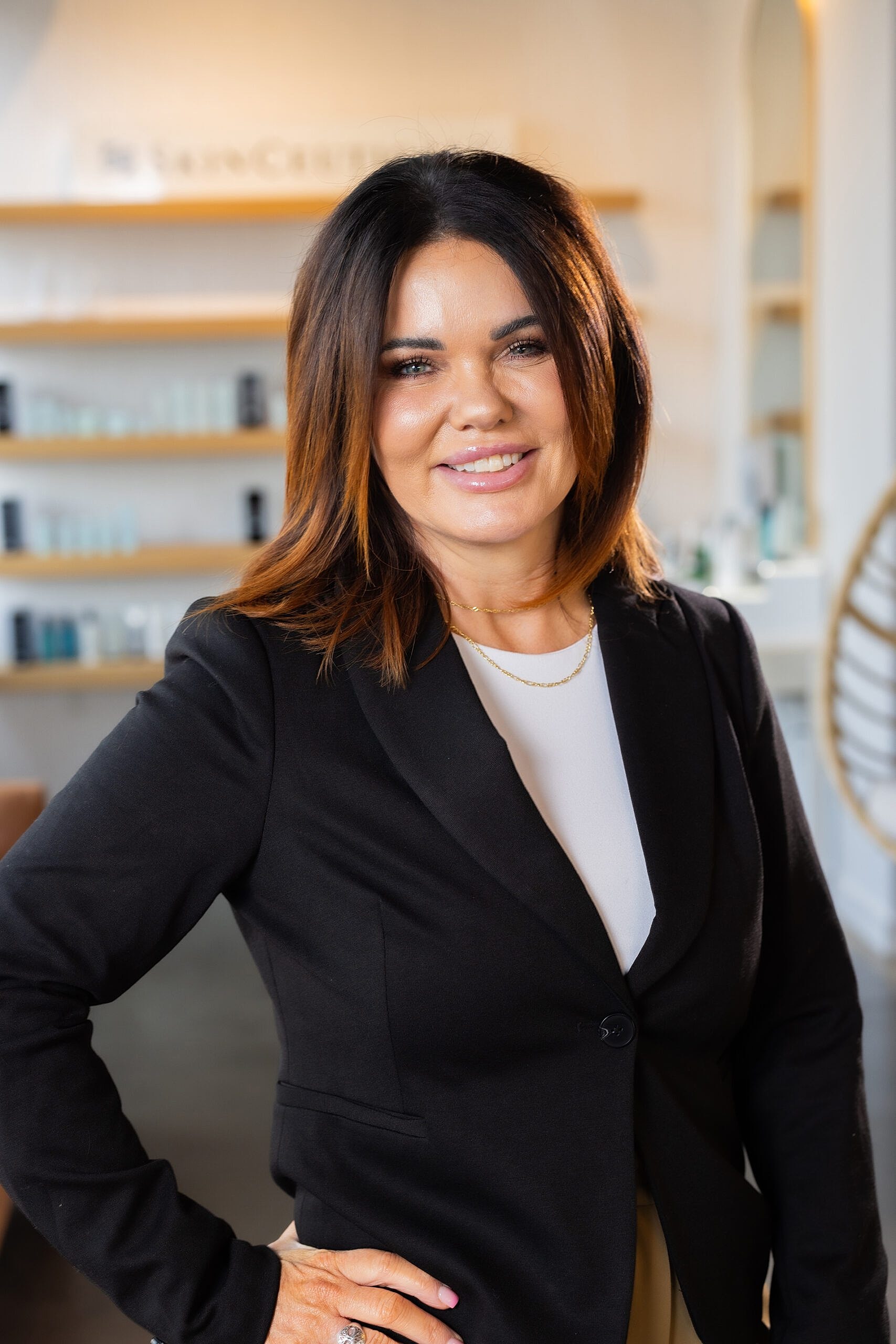 Businesswoman smiling in a salon setting.